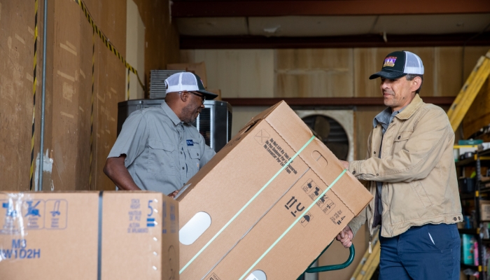 Technicians Moving Box For New Installation